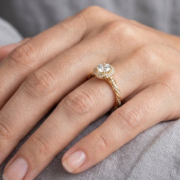 Yellow Gold Engagement Ring Featuring A Round Diamond With Twist Band And Halo