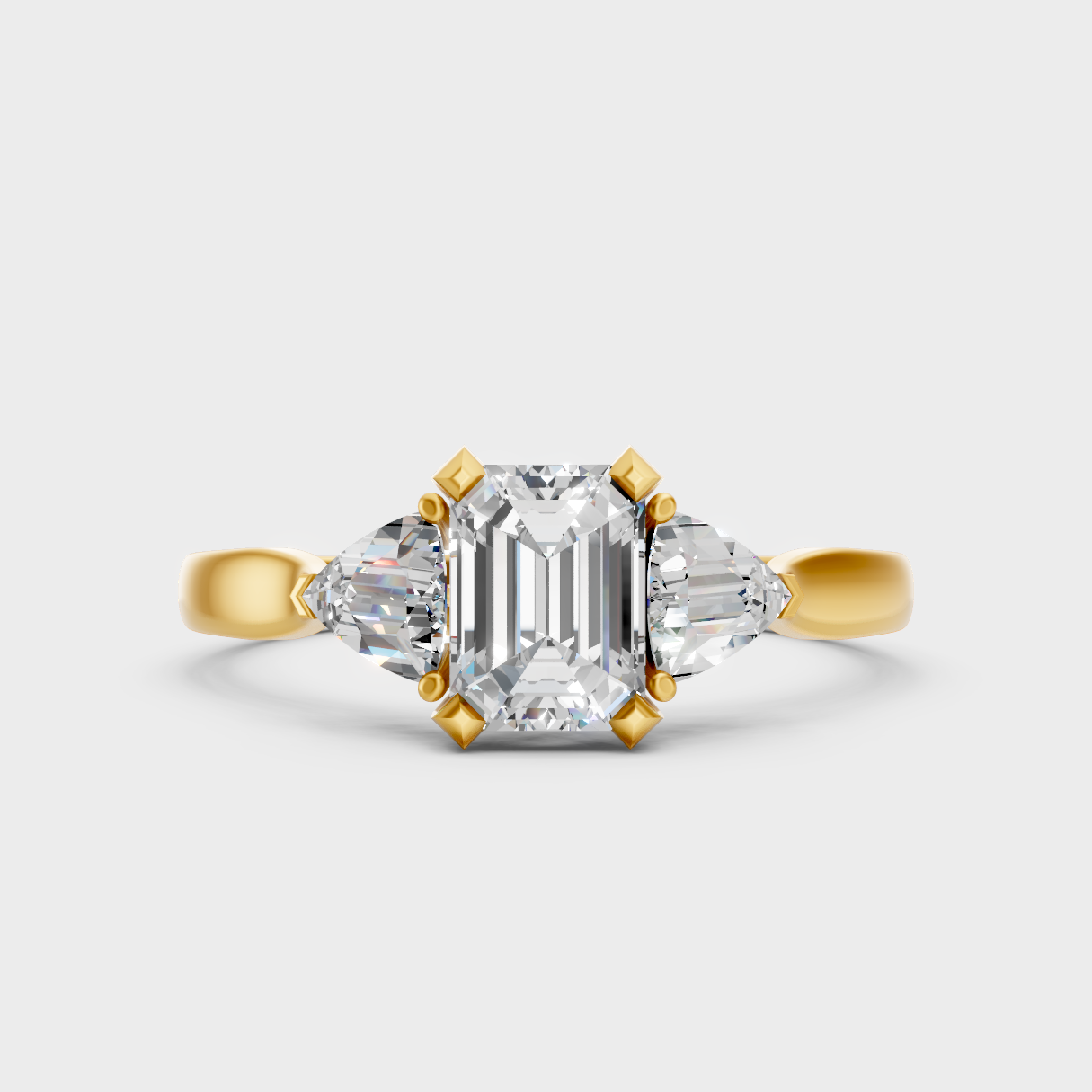 Classic Yellow Gold Three-Stone Engagement Ring Featuring An Emerald Cut And Trillions