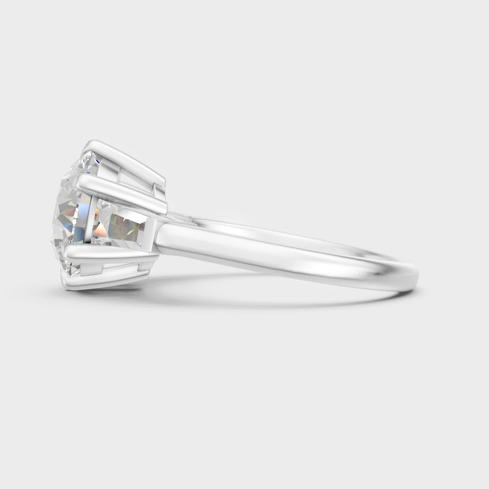 High-polish 950 platinum three-stone ring with a round and baguette-cut blend