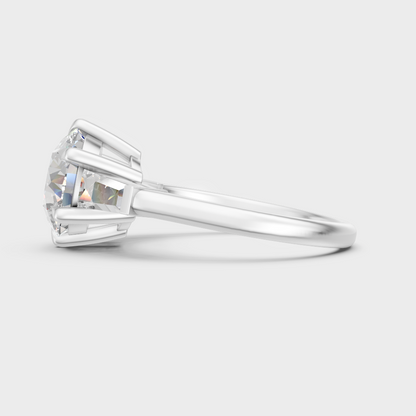 High-polish 950 platinum three-stone ring with a round and baguette-cut blend