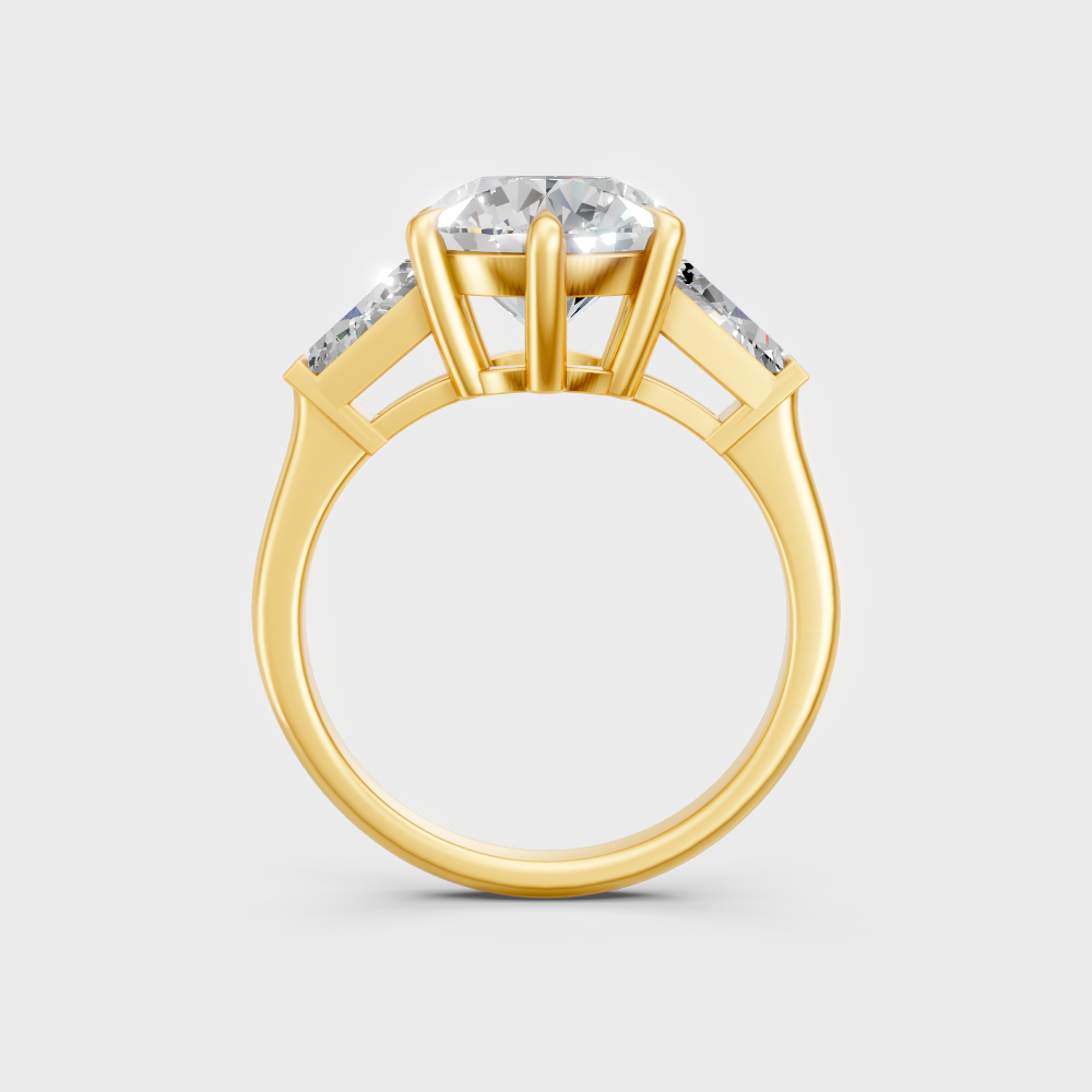 yellow gold three-stone engagement ring with round and baguette ethical diamonds
