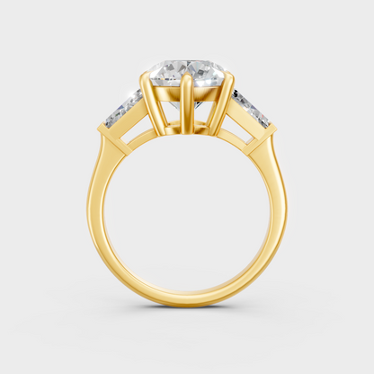 yellow gold three-stone engagement ring with round and baguette ethical diamonds