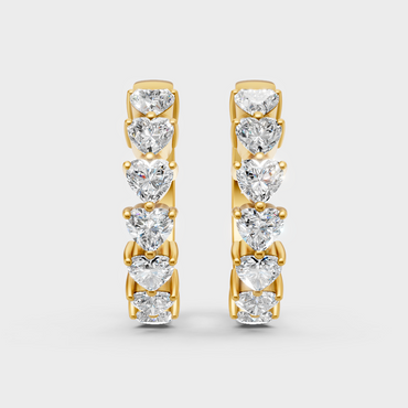 Classic yellow gold hoops featuring heart-shaped lab diamonds per side