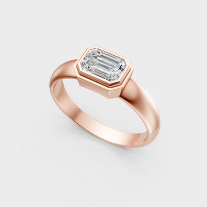 Unique rose gold engagement ring featuring an IGI-certified emerald-cut stone.